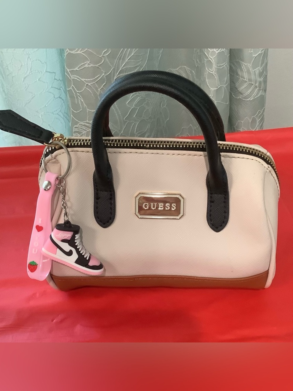 GUESS Mini Beige Satchel with Black Handles and Tan Trim and Pink Keychain